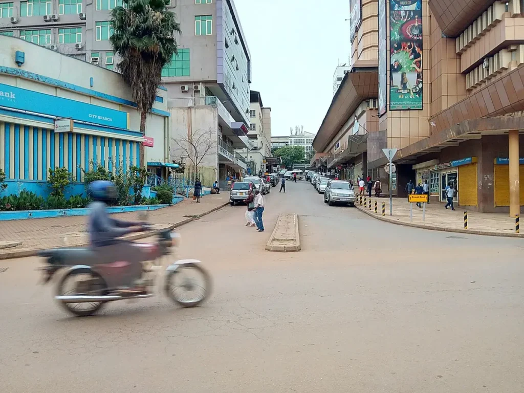 Boda-boda motorcycle moving through Kampala traffic