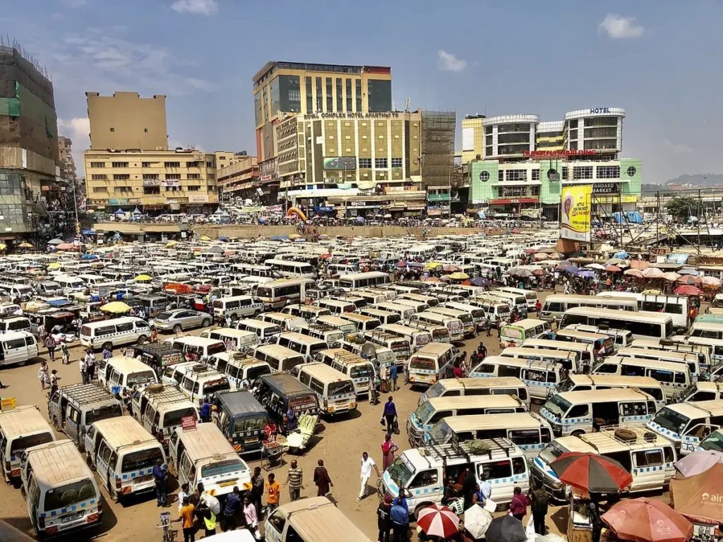 Rows of white minibus taxis at the Old Taxi Park in Kampala