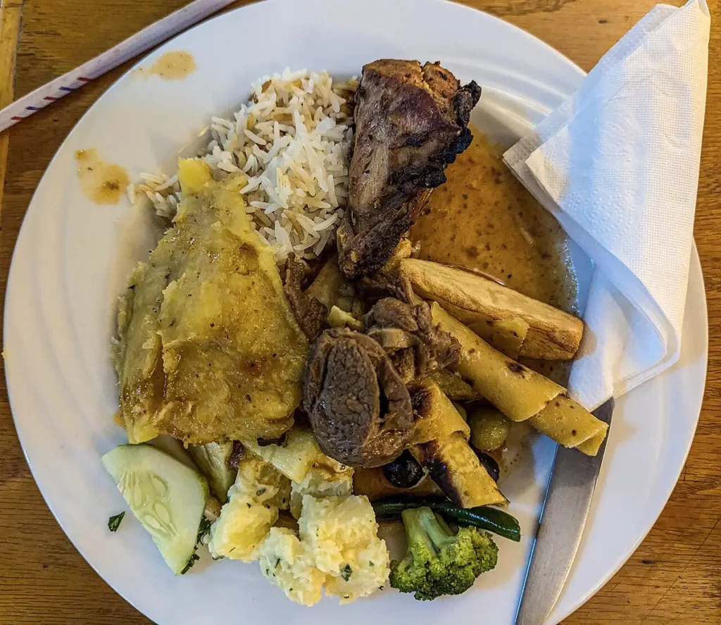 Plate of rice, matooke and chicken from a local canteen